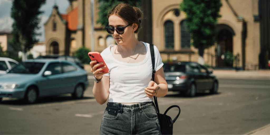 Woman looking at her phone while traveling and deciding on her next destination.